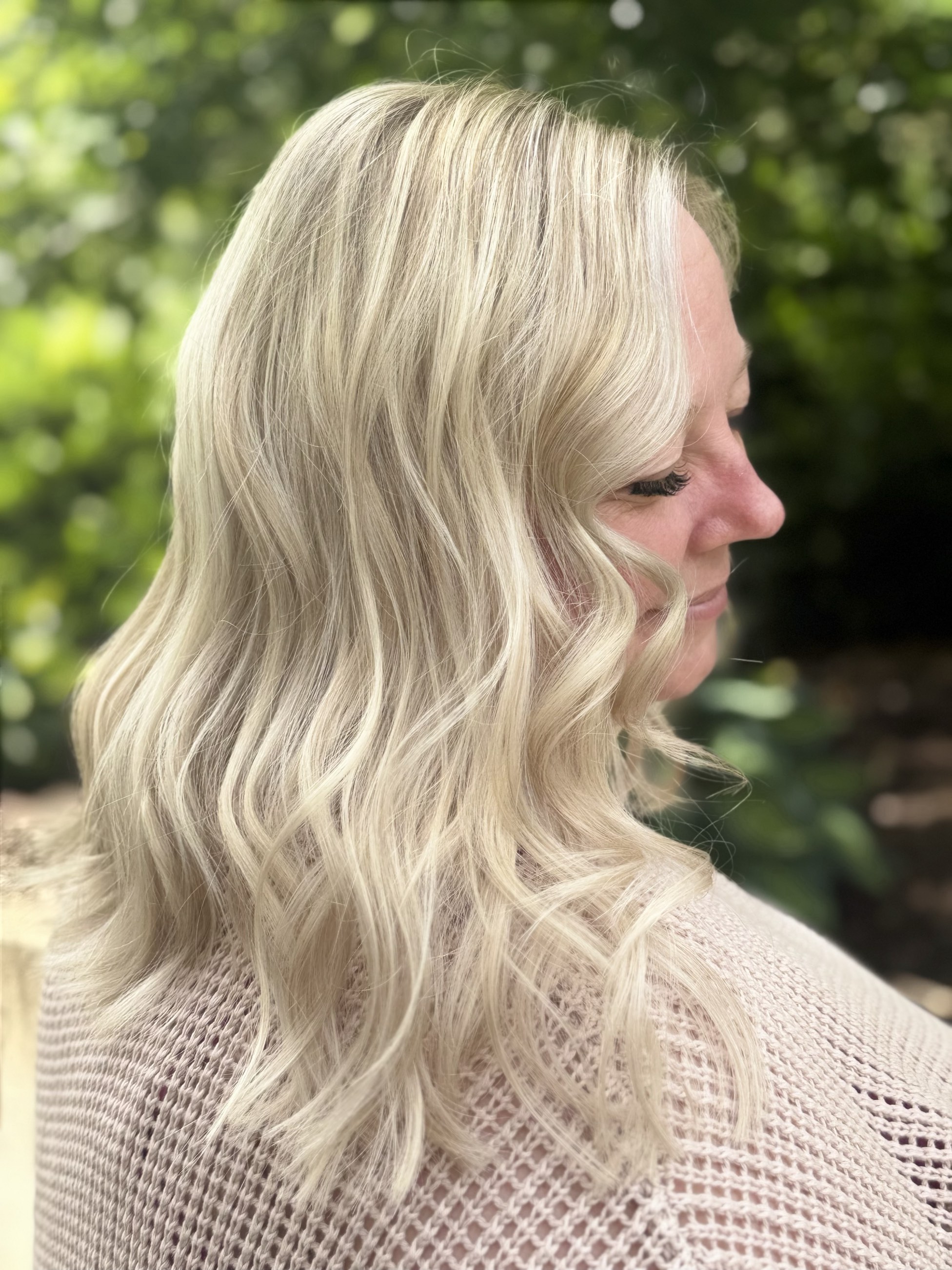 Icy blonde hair styled in soft waves